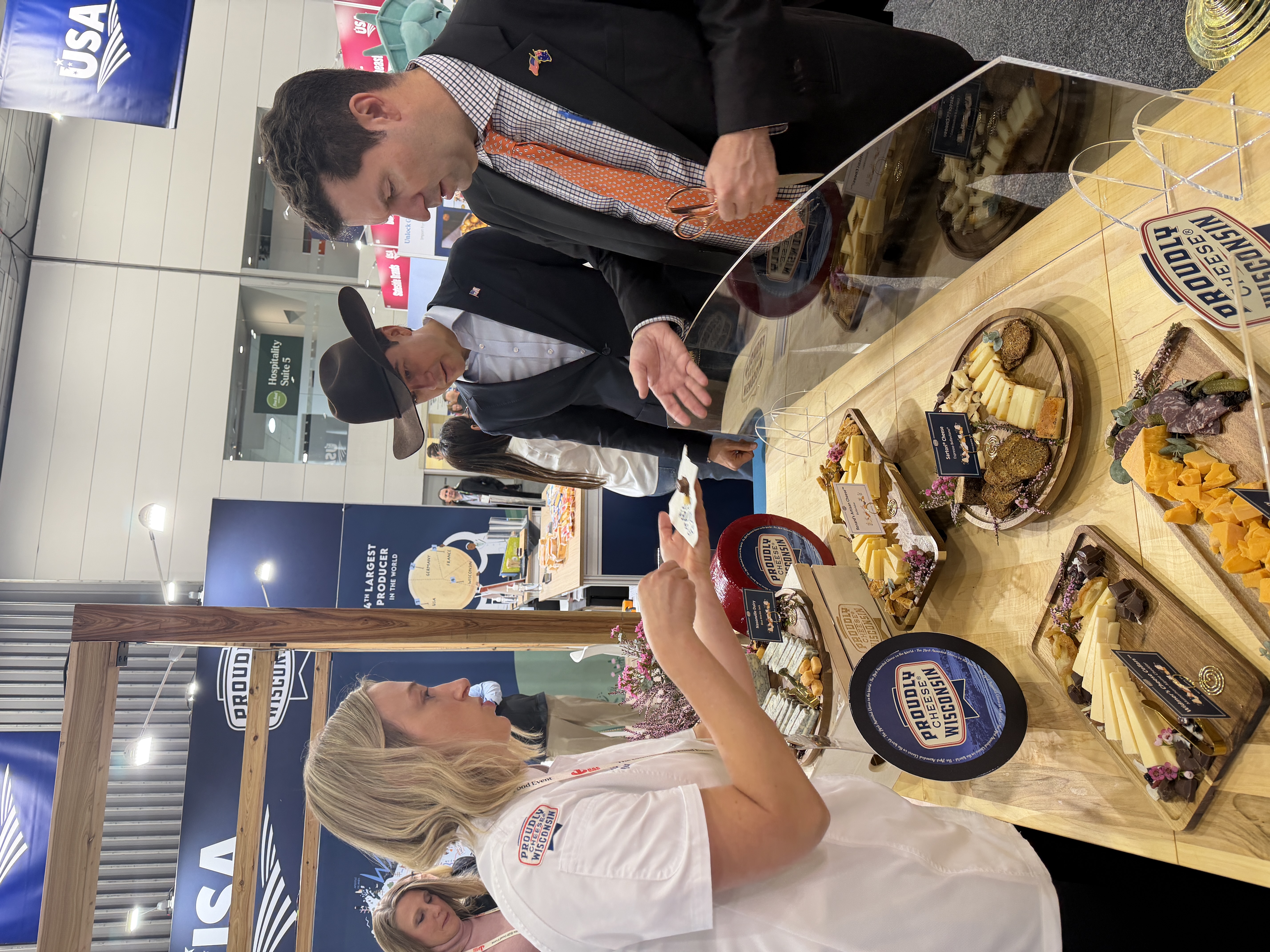 Two men observe the cheese on display at the Proudly Cheese Wisconsin booth.