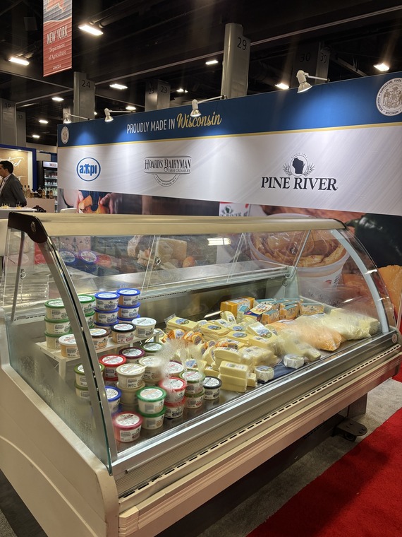 Cheese arranged in cooler at the America's Food and Beverage Show.