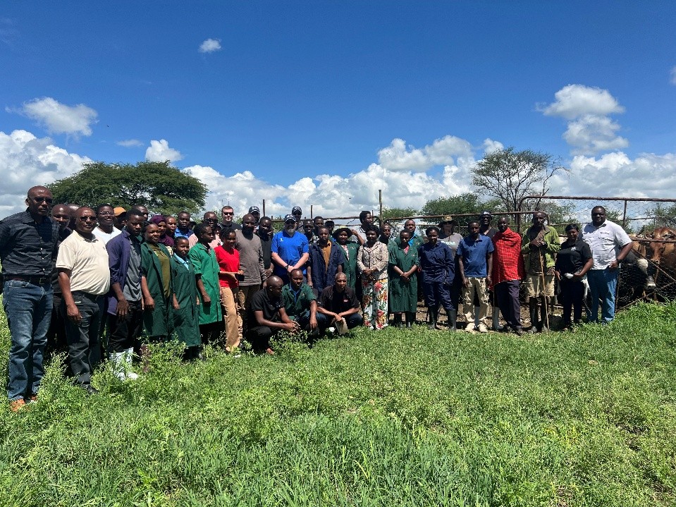 Program participants pose for group photo in pasture